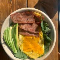 Breakfast Power Bowl 1 - Mixed greens, turkey, bacon, scrambled egg, and cheddar cheese, and avocado. · Cured pork. Beaten and pan fried with seasoning.