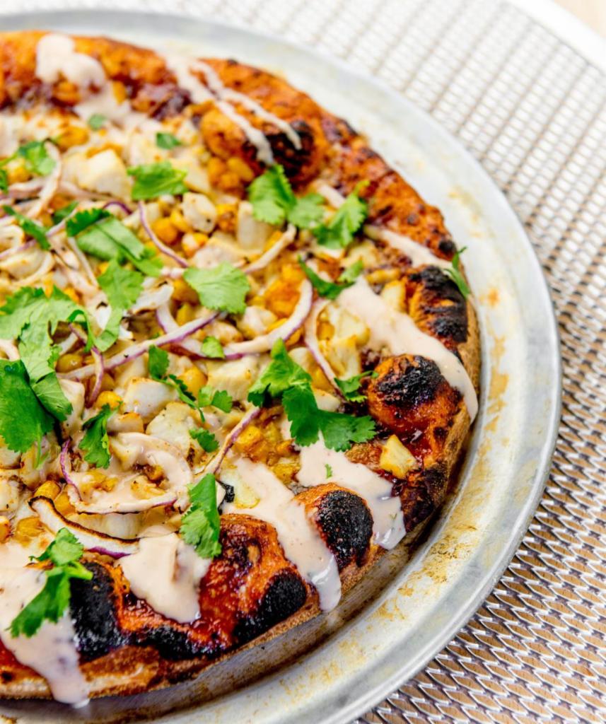 Backyard BBQ Chicken · Traditional crust, sweet BBQ, mozzarella chipotle roasted corn, chicken breast, red onion, smoky ranch and cilantro.  (Other than a crust change, no substitutions.)