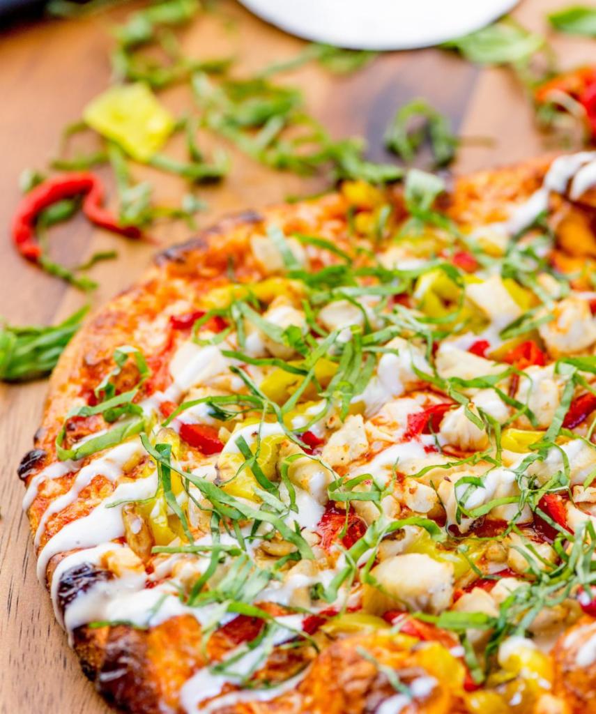Buffalo Chicken · Traditional crust, spicy Buffalo sauce, mozzarella, banana pepper, chicken breast, roasted red pepper, blue cheese dressing and basil. (Other than a crust change, no substitutions.)