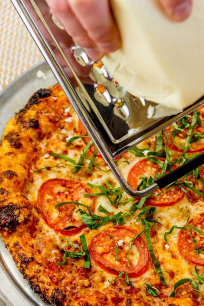Big Cheese Margherita · Traditional crust with parmesan around the edge, tomato blend, mozzarella, roma tomato, garlic oil and basil. (Other than a crust change, no substitutions.)