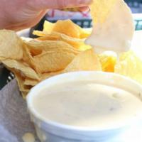 Queso and Chips · A blend of cheeses with a touch of fresh tomato, onion, cilantro and serranos, served with c...