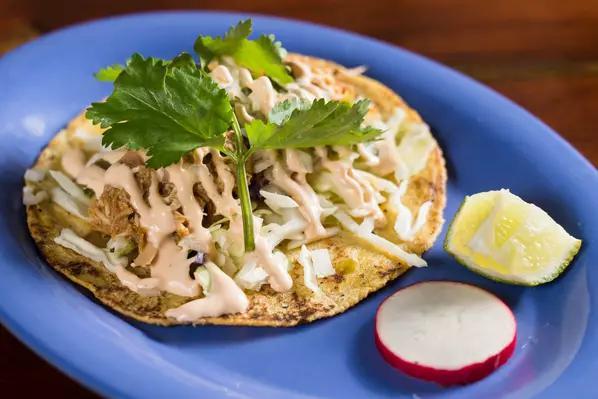 Bohemian Taco · Lime braised chicken, Cali coleslaw, salsa verde, diced onion and chipotle crema. Served with homemade corn tortilla. Gluten free.