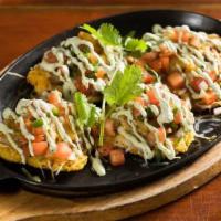 LOCO FRITES · 4 tostones topped with Americano ground beef, cheese, pico and avocado crema.