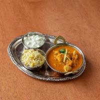 Butter Chicken · Tender, marinated chicken cooked in a spiced tomato cream and butter sauce, topped with cila...