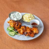 Tandoori Chicken · 1 skewer of boneless, marinated chicken served with cilantro mint and chili sauces.