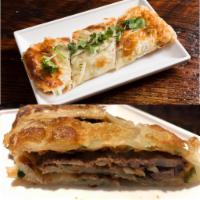 Scallion Pancakes with Beef Brisket · Toasted scallion pancake wrapped around sliced Beef brisket with Hoisin sauce.