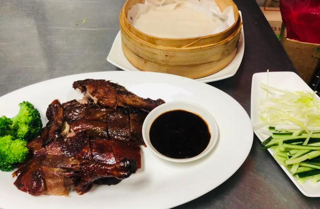 Half peking duck · Half Sliced duck slowly roasted with soy and bbq flavor sauce. Served with 4 pancake wraps and hoisian sauce and shredded scallions