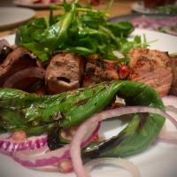 Chargrilled Pasture Raised Pork Mtsvadi · Chargrilled Marinated Pork Loin Cubes, Tangy Red Plum Sauce, Fresh Greens with Pomegranate A...