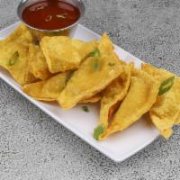 12. Fried Crab Rangoon  炸蟹角 · 8 pieces with cheese inside.