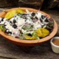 Greek Salad · Red leaf lettuce, red onions, feta, olives and pepperoncinis.