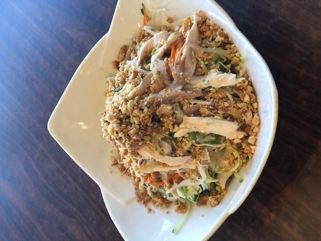 2. Chicken salad with cabbage · *Contains Peanuts* Shredded chicken, carrots, daikon, cucumber, onions, cilantro, fried shallots, & peanuts tossed with house made dressing
