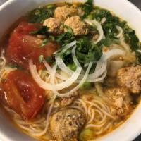 13. Crabmeat and tomato with vermicelli noodle · Fresh tomatoes, crab & pork paste in a tomato based chicken broth served w/ cabbage and shri...