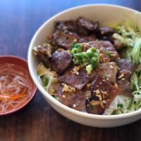 31. BBQ pork with vermicelli · *Contains Peanuts* Flame grilled BBQ pork topped w/ peanuts, scallion, lettuce & shredded cu...