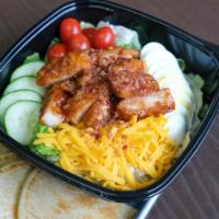 Crunchy BBQ Chicken Salad · Crunchy BBQ chicken, tomatoes, cucumber, egg, shredded cheddar cheese, and topped with crumb...