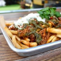 Carnitas Fries · Crispy shoestring fries with slow braised pork carnitas, charred tomatillo salsa, crumble Co...
