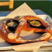 Pub Pretzel · A giant Bavarian pretzel, served with our house-made spicy beer cheese & Mango Cart mustard....