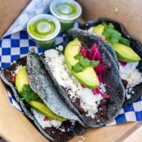 Veggie Taco · Refried black beans, avocado, fresco cheese, pickled red onion, and Mexican cream.