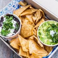 Chips & Guac · Side of guacamole with chips on the side.