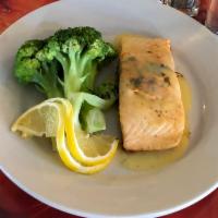 Salmon Steak · Prepared with lemon and herb butter sauce.