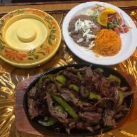 Sizzlin' Fajitas · Deliciously prepared with grilled onions, green and red peppers, tomatoes, and your choice o...