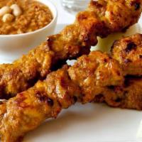 Chicken Satay · Spicy. Three pieces. Marinade chicken breast on skewers served with spicy peanut sauce and l...