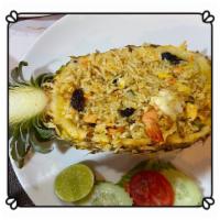 Pineapple Fried Rice · Fried rice with egg, pineapple, corn, carrots, peas, cashew nuts and raisins in Thai curry s...