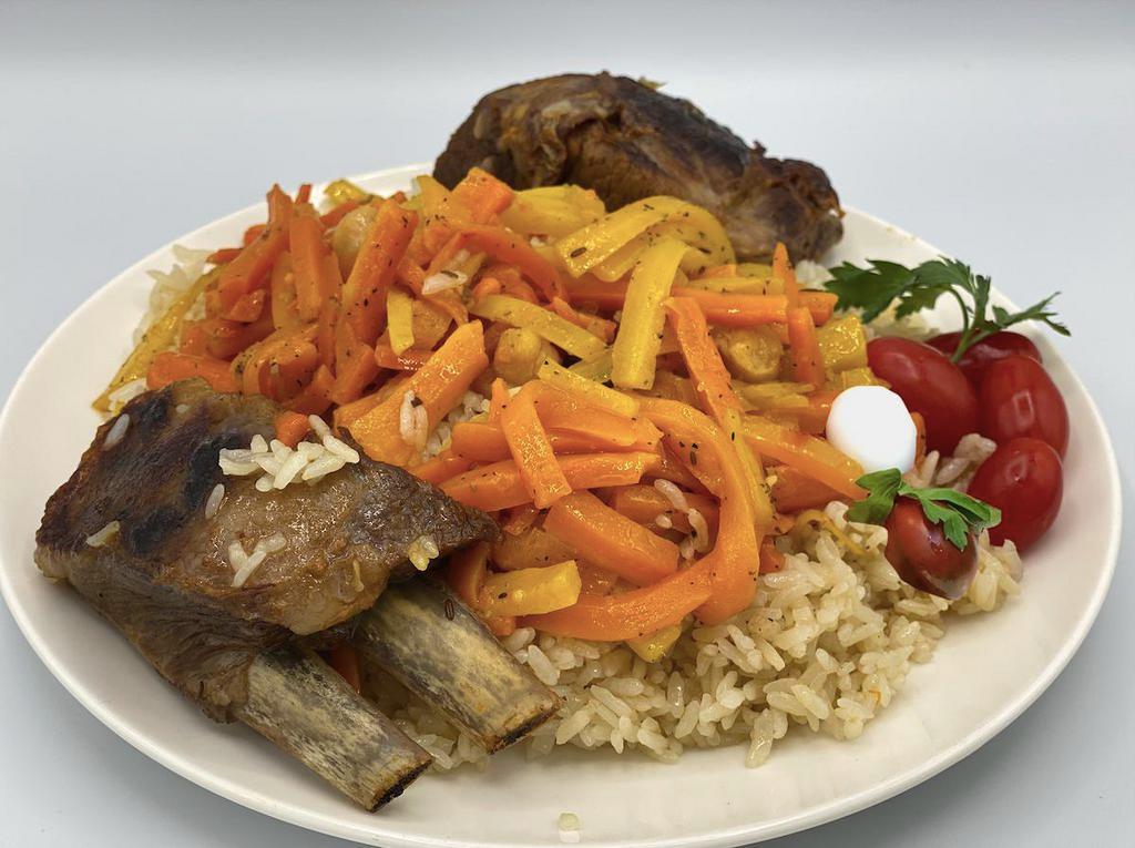Beef Plov · Rice pilaf cooked in a kazan with chunks of beef, carrots, and chickpeas, topped with scallions