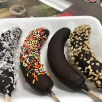 Dipped Bananas · Frozen banana dipped in chocolate with your choice of toppings plain, shredded coconut, rain...