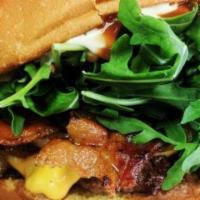 1. The Burger · 1/3 lb. patty, bacon, cheese, caramelized onions, arugula, ketchup & aioli on brioche bun.
