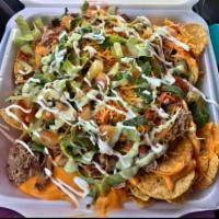 Colten's Carnita's Nachos · Slow-cooked marinated pork butt, onion, cilantro, pineapple, sissy sauce, lime, cheese, and ...