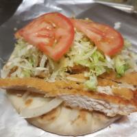 Crispy Chicken on a Pita · Deep fried chicken breast on pita bread topped w/mayo, onions, lettuce, and tomatoes.