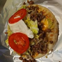 Beef Super Taco · Pita bread with ground beef, American cheese, lettuce, tomatoes and sour cream.