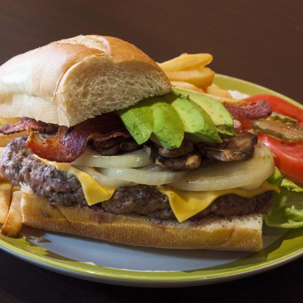 N1. Mahalo's Burger · Ground beef patty, avocado, bacon, American cheese, tomato, lettuce, pickle, sauteed mushroom, and onion on French roll.
