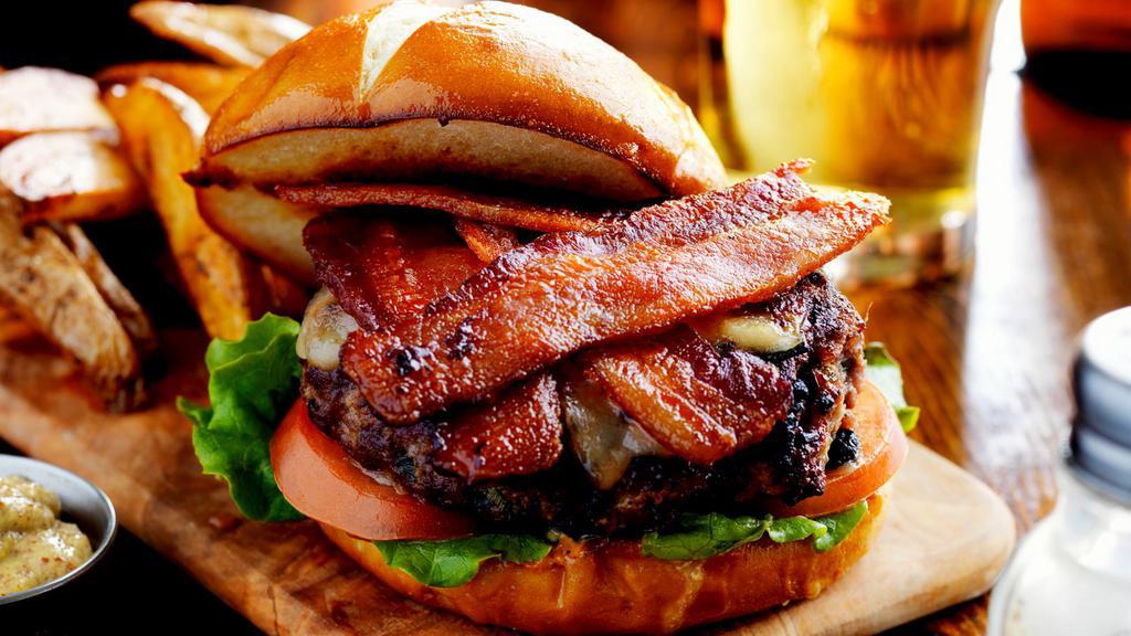 Bacon Cheeseburger a la Carte · Crispy bacon pieces topped on 1/3 lb. of beef patty, slices of red tomatoes, red onions, lettuce, mayonaise, ketchup and mustard.