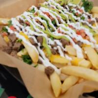 Carne Asada Fries · Straight Cut French Fries topped with shredded cheddar/jack cheese, carne asada, and your ch...