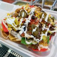 Nachos · House made chips with your choice of protein. Fillings and sauce.