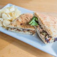 Chicken Paradiso Panini · Grilled chicken breast, sun-dried tomato pesto, red onions, greens and fontina cheese with b...