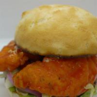 Crispy Buffalo Tender Sandwich · Two hand breaded tenders, lettuce, tomato, onion, side of pickles, bun and one side.