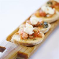 Bruschetta · Toasted crostini topped with chopped tomato, garlic, basil and extra virgin olive oil.