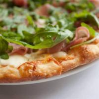 Pizza Milano · Prosciutto di Parma, arugula, mozzarella, provolone and extra virgin olive oil. Bianca.
