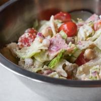 Antipasto Salad · Iceberg, mom's Italian dressing, salami, brick cheese, tomato, onion, chickpeas and Parmesan.