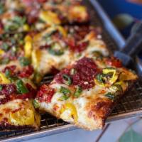 The WIMP Pizza · Calabrian chilies, jalapeno, banana peppers, house-made spicy honey.