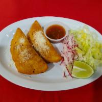 Empanadas Guatemaltecas · 2 pieces. Folded handmade tortillas deep fried with vegetables and chicken. lettuce, radish ...