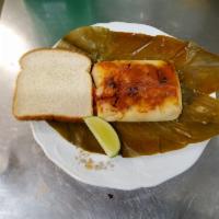 Tamal Guatemalteco · Made with traditional Leaves. Chicken, mole, red pepper, raisins with bread. 