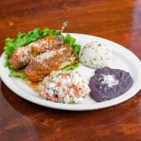 Chiles Rellenos · Poblano pepper stuffed with chicken or beef, side salad, rice, and beans.