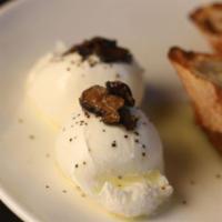 Burrata and Truffles · Creamy burrata cheese with black truffle, white truffle oil and grilled baguette on the side