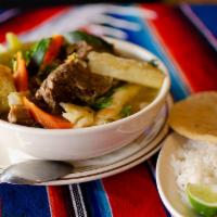 Sopa de Res · Beef soup, served with rice and tortillas. Served with cilantro on top.