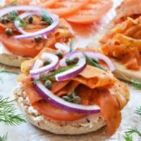 Lox and Cream Cheese Bagel Breakfast · Cashew cream cheese, carrot lox, cucumber, capers and chives on a sprouted bagel.