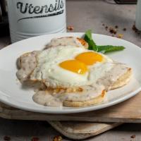 **Biscuits & Gravy · Two homemade biscuits topped with sausage gravy and two eggs any style. Sorry no choice of s...