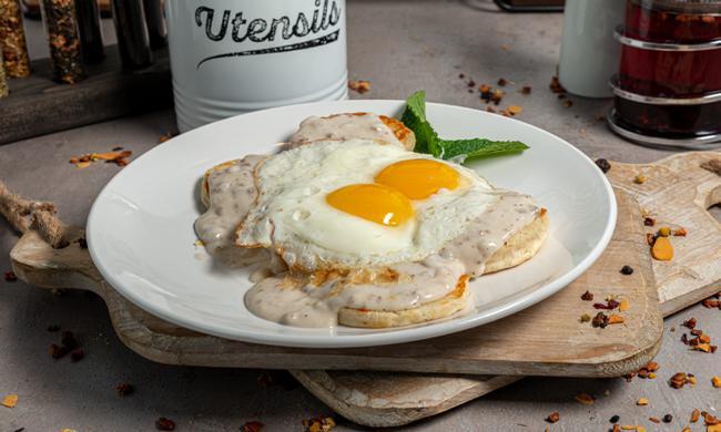 **Biscuits & Gravy · Two homemade biscuits topped with sausage gravy and two eggs any style. Sorry no choice of sides with this dish